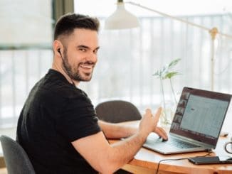 online tutoring man in black t-shirt using macbook pro