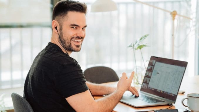 online tutoring man in black t-shirt using macbook pro