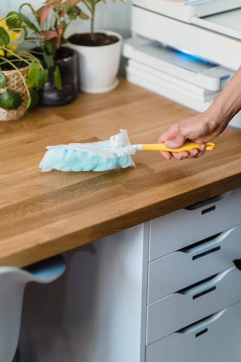 Person Holding Yellow Handle Swiffer