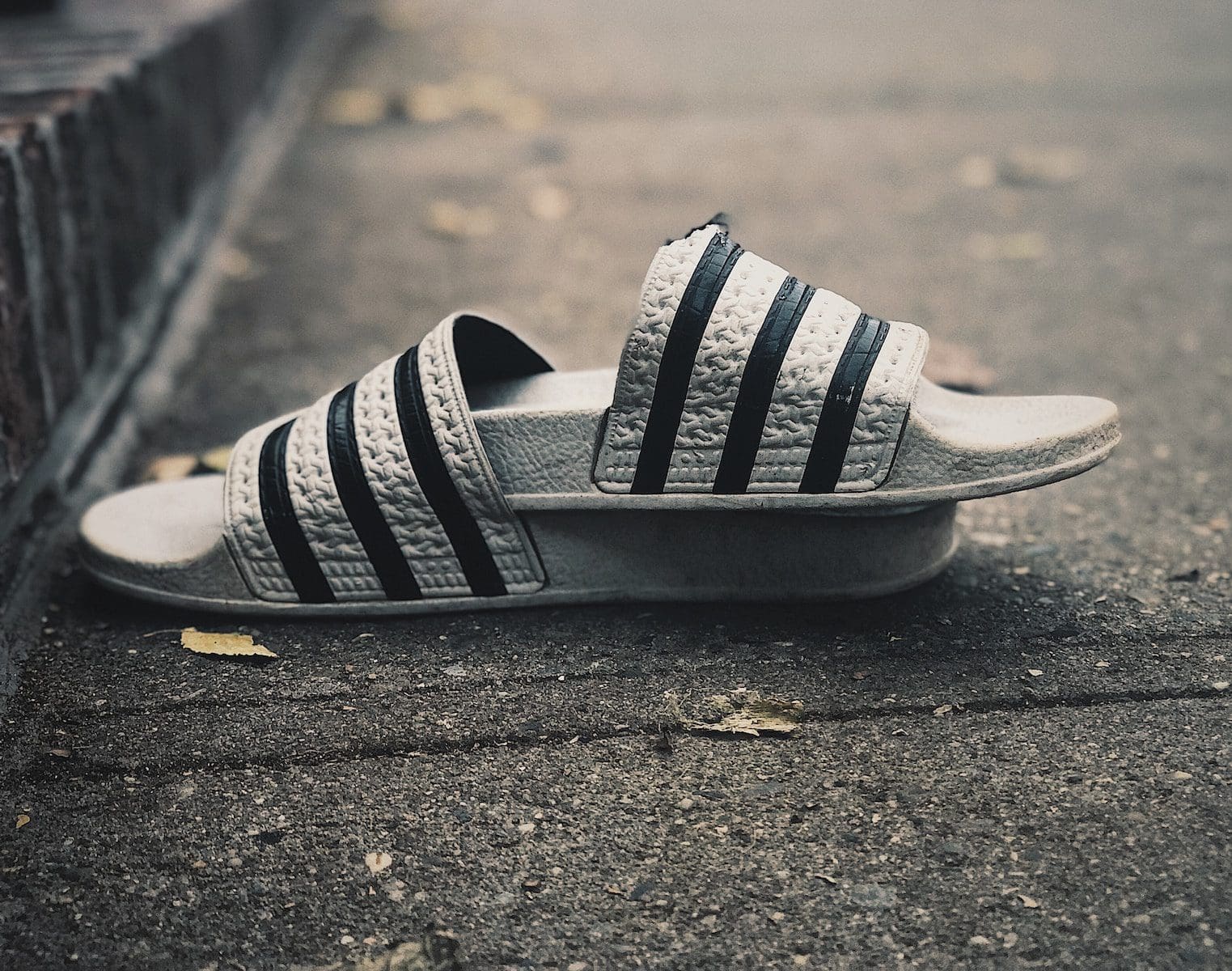 a pair of black and white shoes laying on the ground