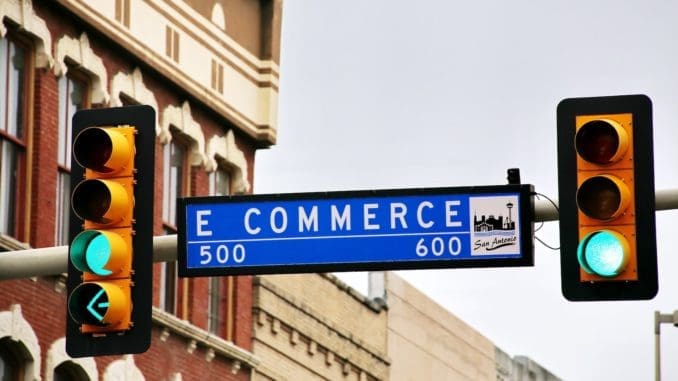 a traffic light with a street sign hanging from it's side online marketplaces