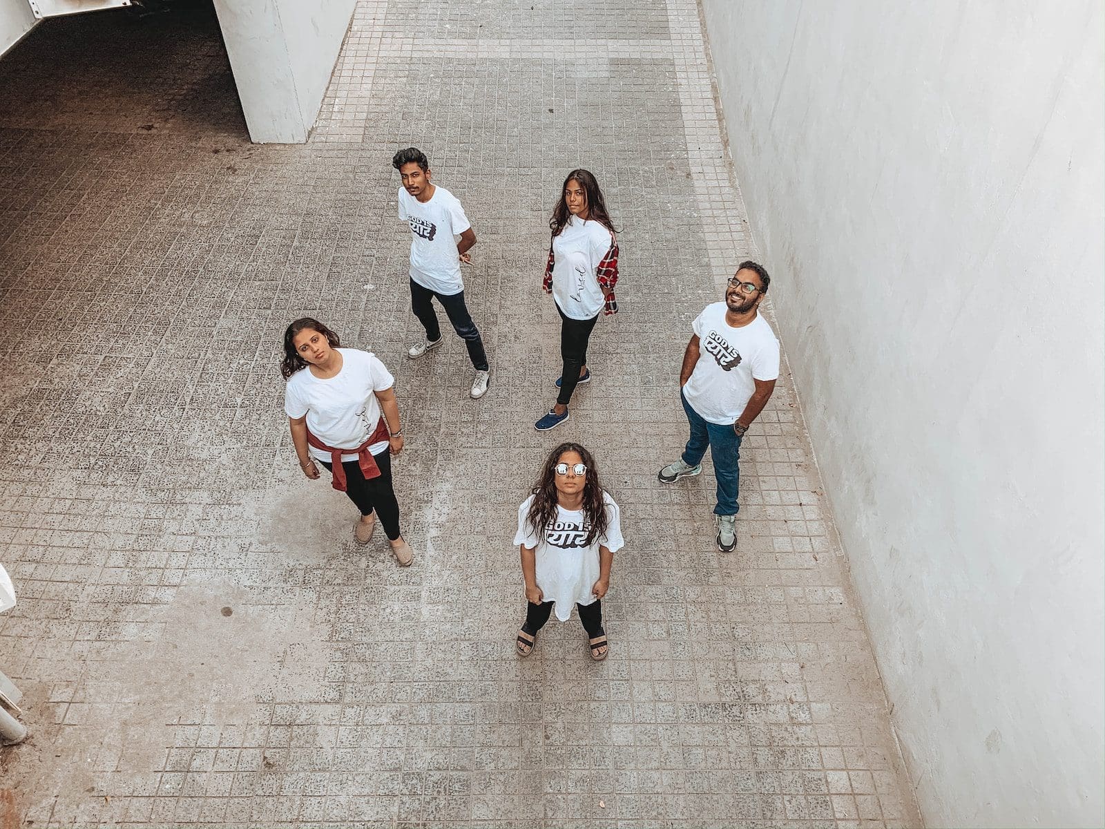 group of people in white shirt and black pants standing on gray concrete floor