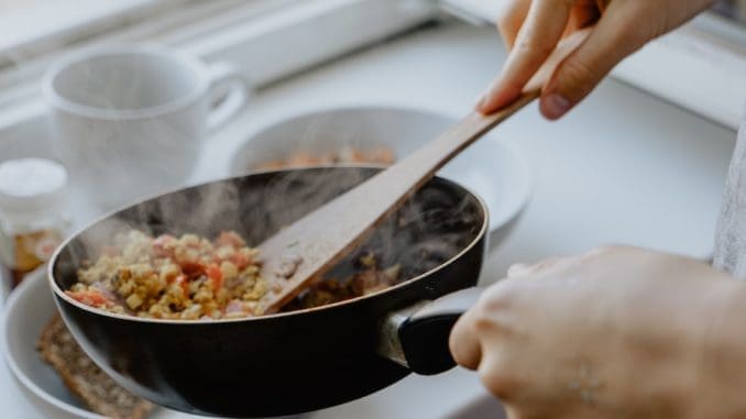 person holding black frying pan