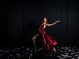 woman model wearing red tank satin high slit dress