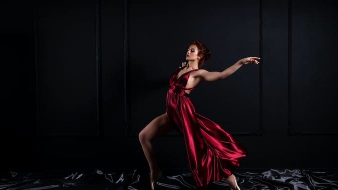 woman model wearing red tank satin high slit dress