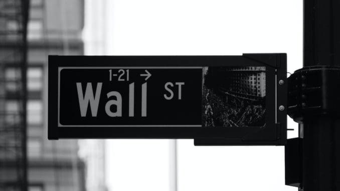 grayscale photo of Wall St. signage stock investment