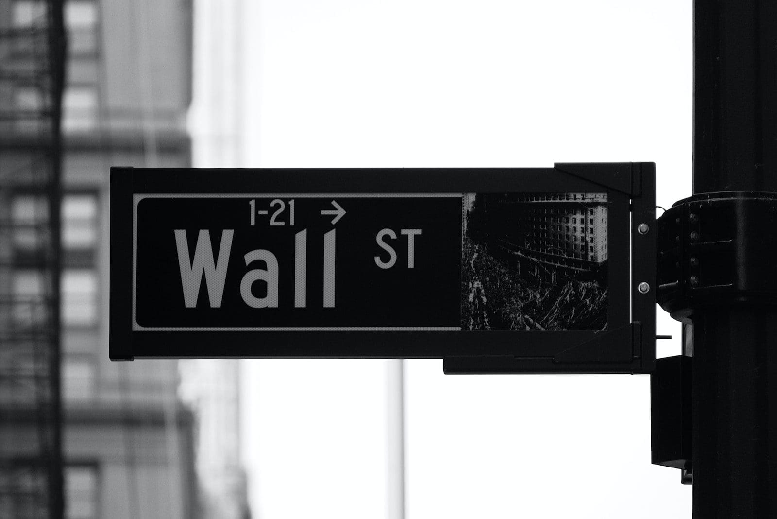 grayscale photo of Wall St. signage stock investment