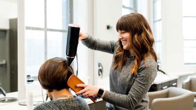 woman holding hair salon dryer