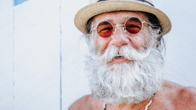 a man with a white beard and mustache wearing a hat healthy living