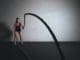woman holding brown ropes cardio