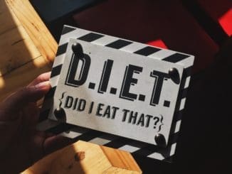 person holding DIET Myths quote board