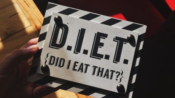 Photo by Jamie Matociños person holding DIET Myths quote board