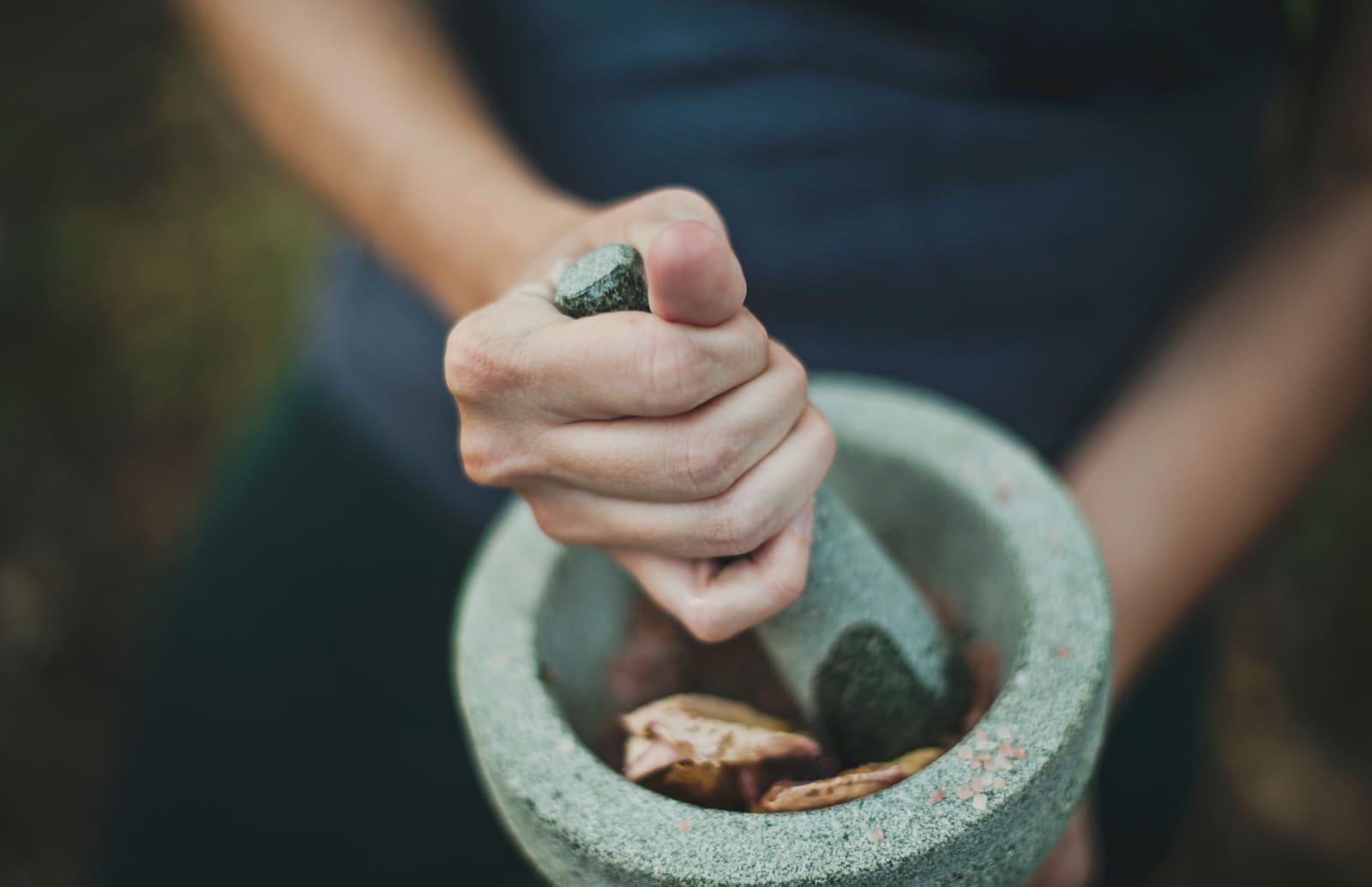 How To Start An Herbal Remedy Business 1 person grinding on mortar and pestle