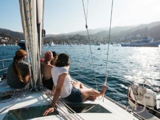 people sitting on front of yacht sailing vaction