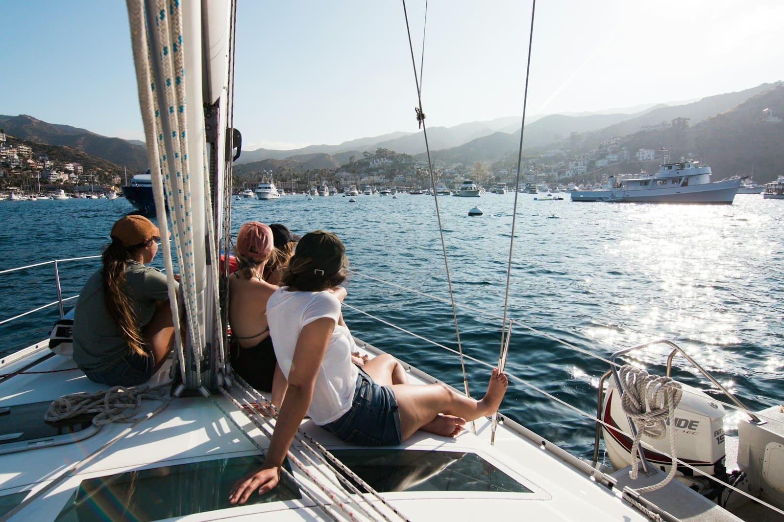 people sitting on front of yacht sailing vaction