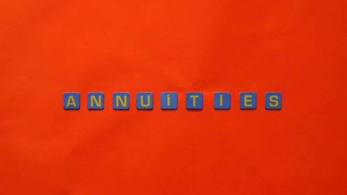 Conceptual image of the word annuity 'Annuities' spelled with tiles on a vibrant red background.