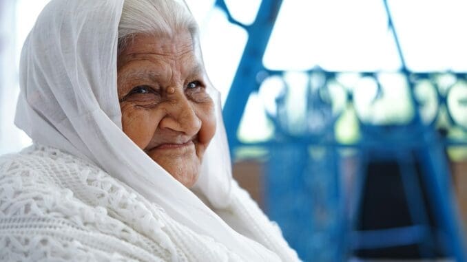 close-up photo of woman sitting while smiling Attendant for the Elderly
