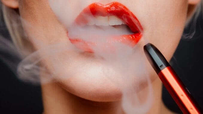 woman with red lipstick and red lipstick vaping