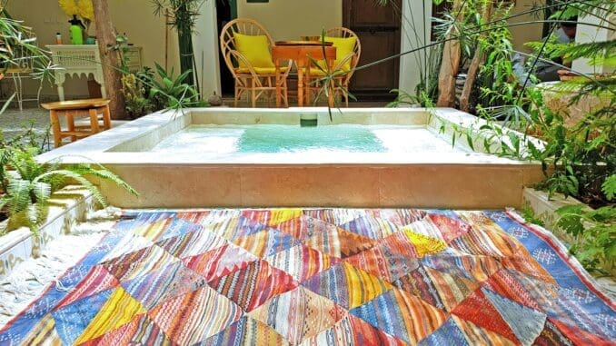 yellow and brown chair beside table stylish rugs