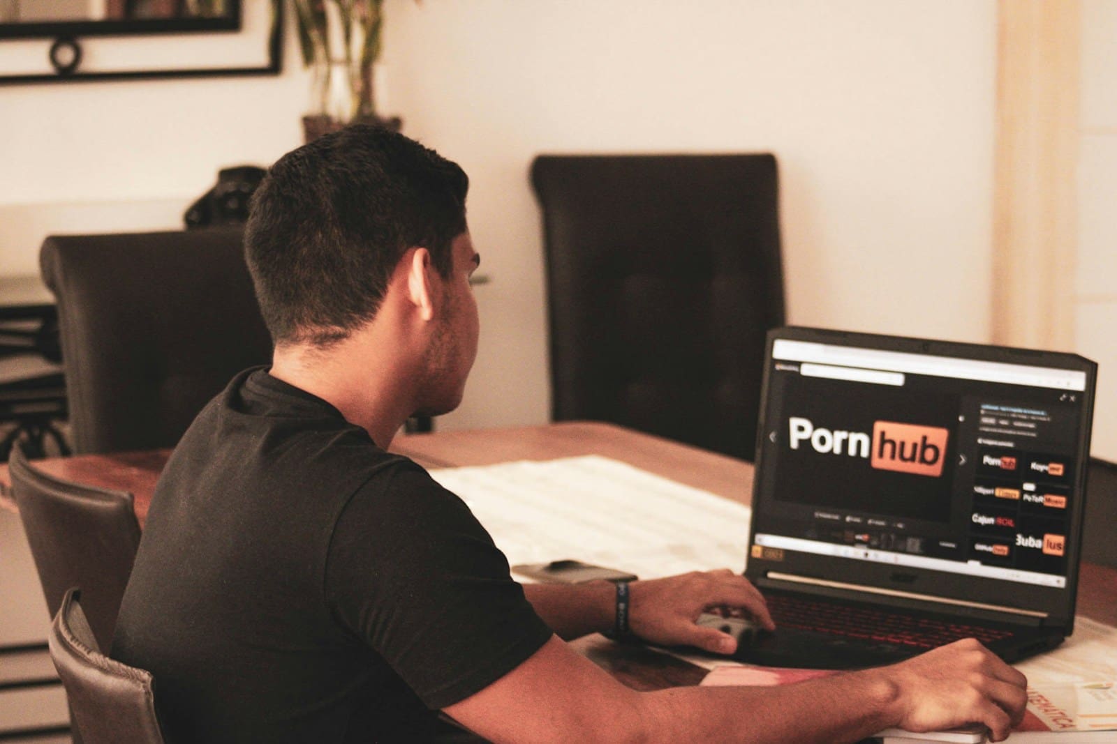 man in black t-shirt using black laptop computer porn