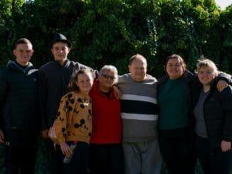 family ties group of people standing near green trees during daytime