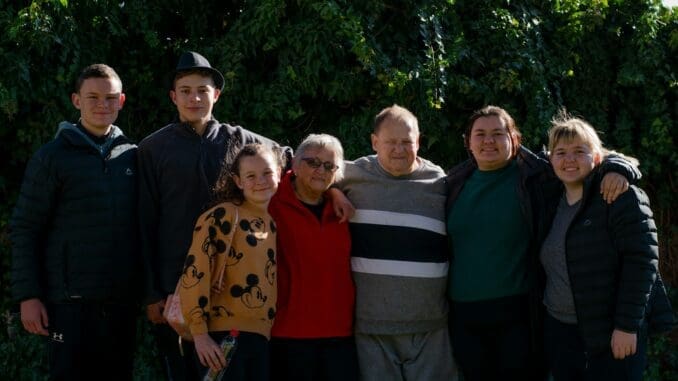 family ties group of people standing near green trees during daytime